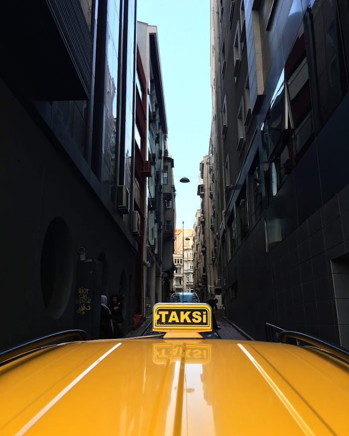 pexels-photo-2591894 Photo of Yellow Taxi on Narrow Street